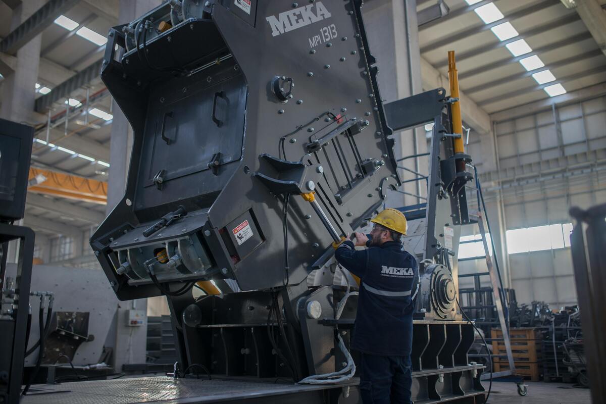 Worker servicing industrial machinery